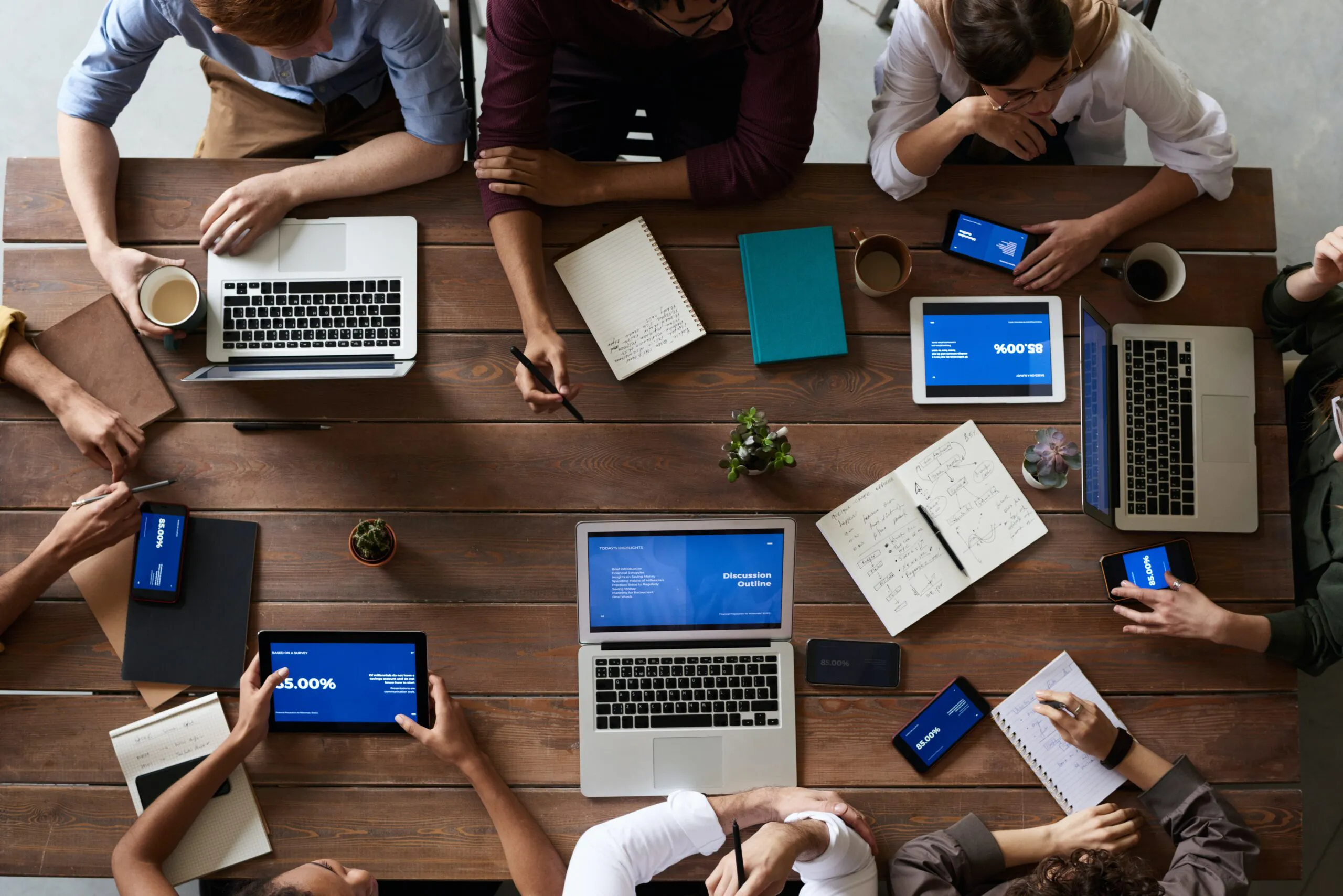 Team working together at a table with laptops